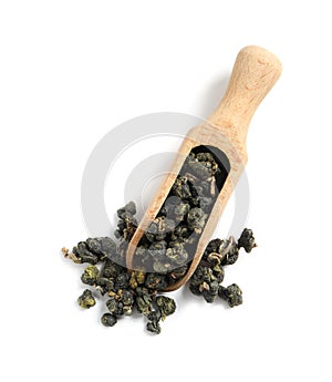 Wooden scoop with Ali Shan Oolong tea on white background