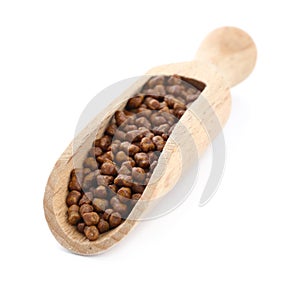Wooden scoop with buckwheat tea granules on white background