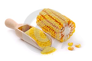 Wooden scoop with corn flour on white background.