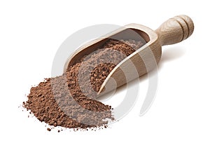 Wooden scoop with crude cocoa powder isoladed on white background photo