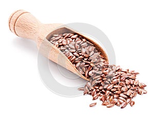 Wooden scoop with flax seeds on white photo