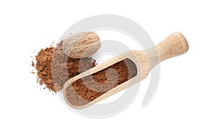 Wooden scoop with nutmeg powder and seed on white background, top view