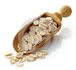 Wooden scoop with oat flakes