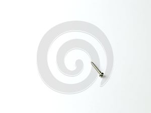 A wooden screw on a white matt background