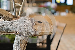 A wooden sculpture that looks like animal placed in the foreground and blurred cafe environment
