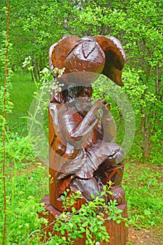 Wooden sculpture of musician in Dendrology garden in Pereslavl-Zalessky city