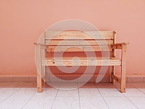 Wooden seat front pink background