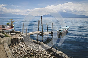 Wooden seat at jetty along lake Atitlan at the coast of Santa Cruz la Laguna, Guatemala