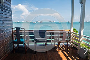 Wooden seats of coffee cafes by the sea in summer at Pattaya