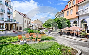 Wooden seats with a lot of green in Pedestrian zone in centre of spa town Piestany SLOVAKIA