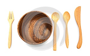 Wooden set knife fork and spoon put near circle wood bowl for serve.  isolated on white background.  equipment handmade in thai tr