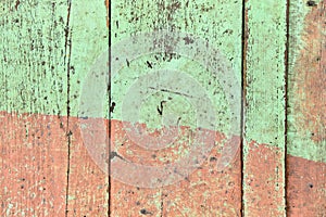 Wooden shabby fence painted in light green and beige color. Texture, background