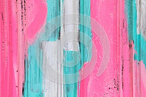 Wooden shabby fence painted in white, turquoise and pink. Texture, background