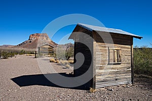 Wooden shacks in desert setting