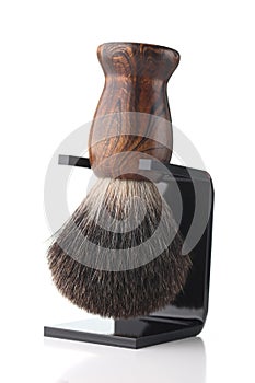 Wooden shaving brush on stand isolate on white