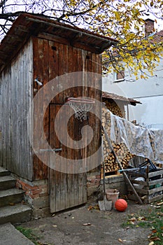 Wooden shed basketball hoop, ball and firewood