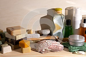 Wooden shelf in bathroom with various face and body care products. Handmade soap, essential oils, cleansers, wooden