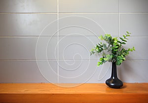 Wooden shelf on the tile wall.