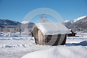 Wooden shelter at snowy valley in the bavarian alps