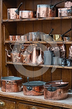 Wooden shelves full of pots and pans