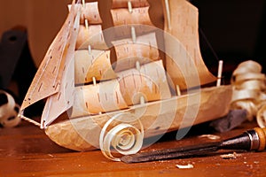 Wooden ship toy workshop carpenter with a plane, chips, birch bark, homemade