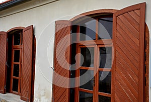 wooden shutters for arch-shaped balcony windows.