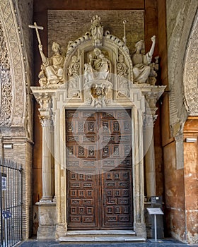 Wooden side door in the Puerta de Perdon or Door of Forgiveness, the visitors entrance to the Seville Cathedral on Alemanes Street