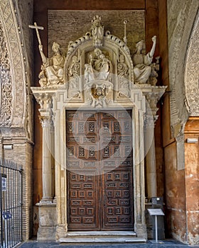 Wooden side door in the Puerta de Perdon or Door of Forgiveness, the visitors entrance to the Seville Cathedral on Alemanes Street photo