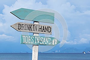 Wooden sign board on the beach and blue sky with sea background