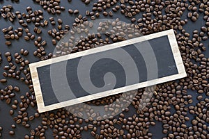 Wooden sign and coffee beans on wooden table background