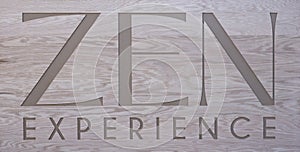 wooden sign with engraved text Zen Experience