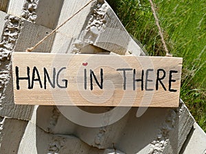 Wooden sign hang in there