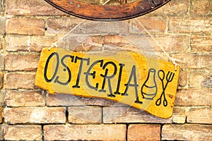 A wooden sign with the inscription Osteria photo