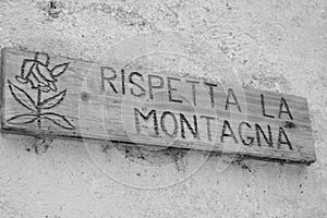 Wooden sign that says respects the mountain