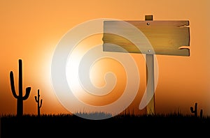 Wooden sign at sunset on the prairie