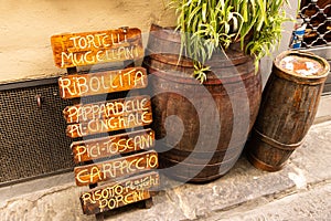 Wooden sign with a typical tuscan menu in a street of touristic city of Florence