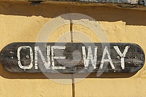 Wooden sign on the wall that says `one way`