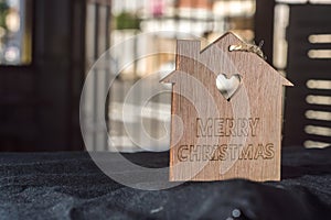 wooden sign written "Merry Christmas" with copy space and black background, Christmas concept