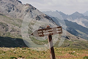 Wooden signage in a mountain range with French words Col de longet Col Blanchet photo