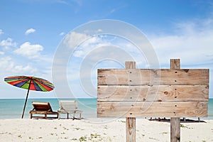 wooden signboard on blue sky , tropical beach for summer background .