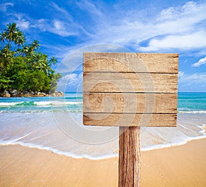 Wooden signboard on tropical beach photo