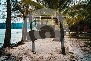 wooden signboard on tropical beach. A sign board for the name of the hotel or the beach on a background of beautiful nature on