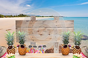 wooden signboard on tropical beach for summer background.