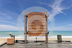 Wooden signboard and wood floor on beach for summer background.