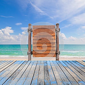 wooden signboard and wood floor on beach for summer background.