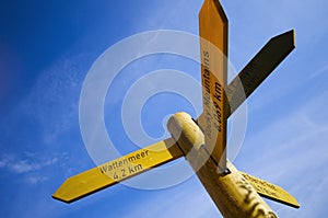 Wooden signpost on blue sky