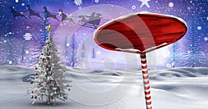 Wooden signpost in Christmas Winter landscape and Santa`s sleigh and reindeer`s and Christmas tree