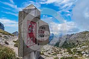 Wooden signpost for hikers in Mallorca along the GR 221