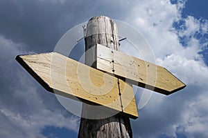 Wooden signpost with two arrows