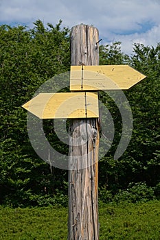 Wooden signpost with two arrows